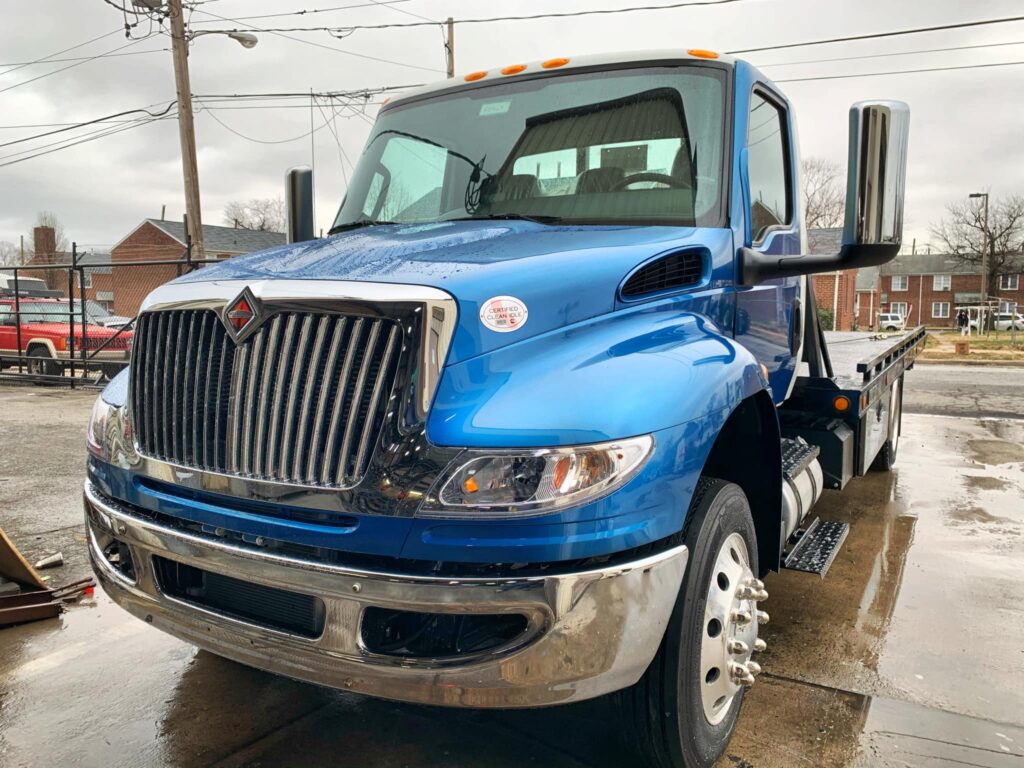 north-east-auto-body-shop-blue-tow-truck-